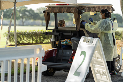 Residents of The Villages® drive up in golf carts to get tested at the COVID-19 testing site set up by UF Health. — © University of Florida, Photo by Jesse S. Jones