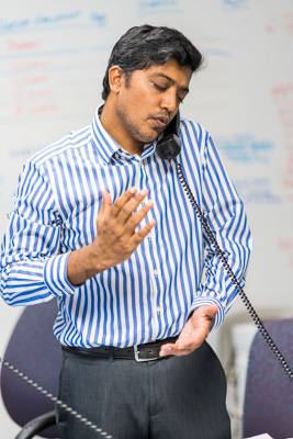 Dr. Kartik Cherabuddi, M.D., FACP, an expert in infectious diseases, fields a phone call in the UF Health Shands COVID-19 Command Center in the early stages of the pandemic. — © University of Florida, Photo by Louis Brems