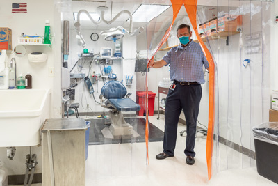 John H. Hardeman, D.D.S., M.D., a clinical associate professor at the UF College of Dentistry, tours updated clinical spaces after staff made modifications to facilitate patient safety in the COVID-19 era. — © University of Florida, Photo by Jesse S. Jones