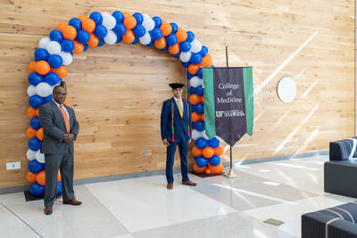 COVID-19 reshaped many aspects of college life in 2020, including graduations. Christian Archer, M.D., UF College of Medicine Class of 2020, poses for a physically distanced graduation photo with then Interim Dean Joseph A. Tyndall, M.D., M.P.H. — © University of Florida, Photo by Jesse S. Jones
