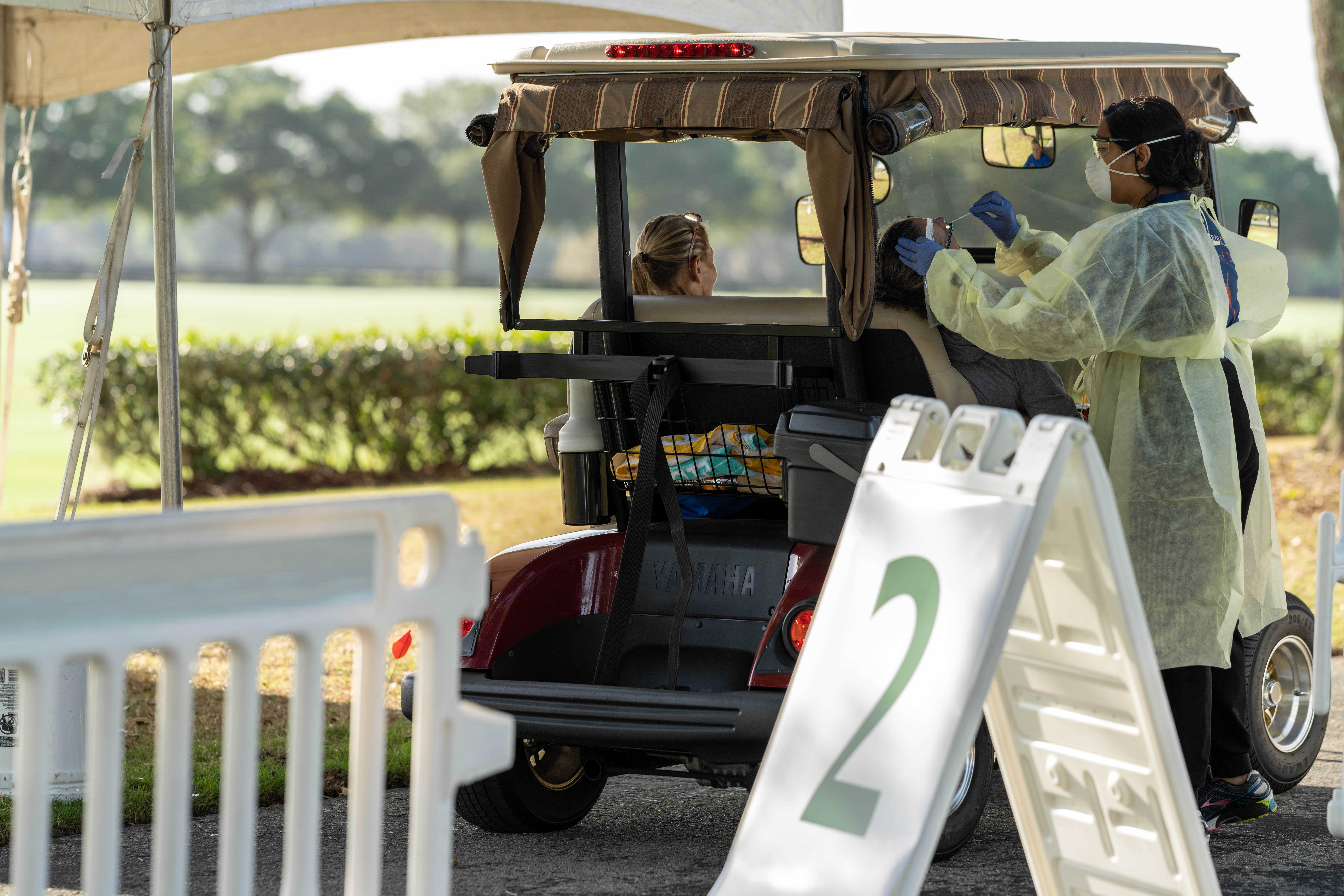 Residents of The Villages® drive up in golf carts to get tested at the COVID-19 testing site set up by UF Health.