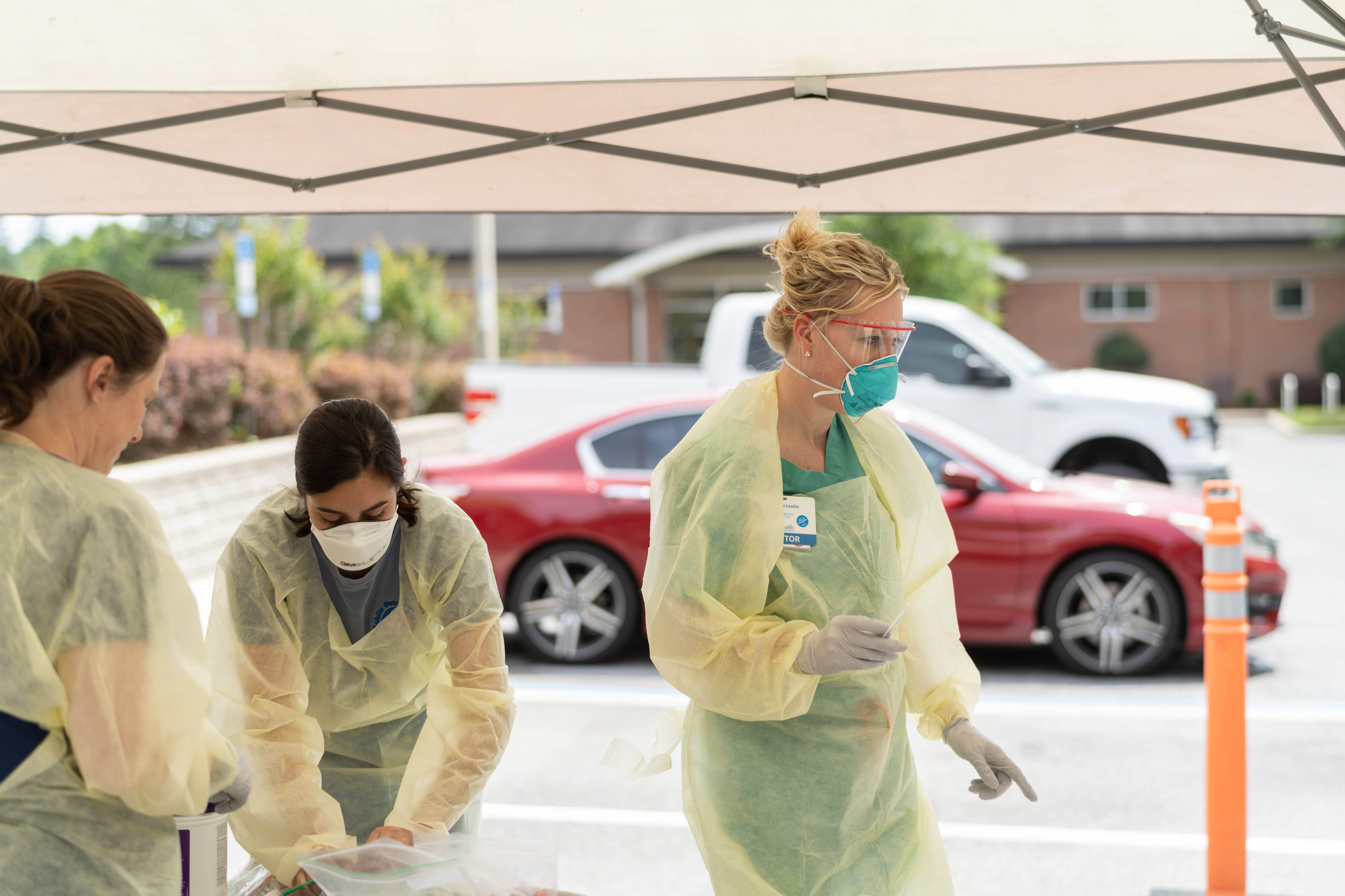 Michele Lossius, M.D., UF Health chief quality officer, along with other UF Health clinicians work a drive-thru testing site at UF Health Shands Emergency Center – Springhill.