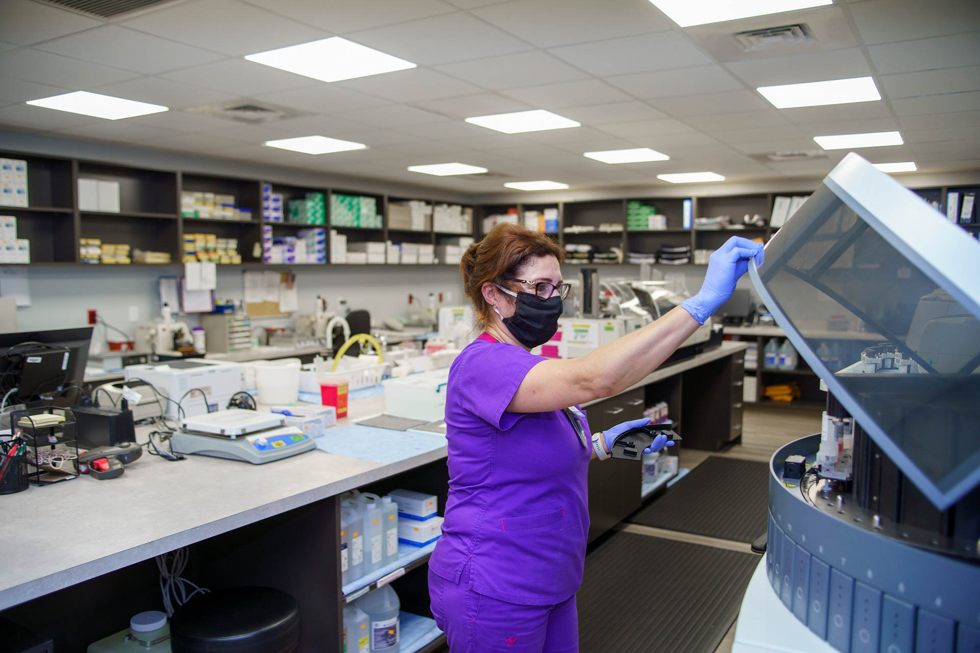 Carmen Quintana, histology supervisor for UF Health Alliance Laboratory, prepares a specimen for analysis in the Leesburg pathology lab.