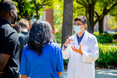 Dr. Lauzardo, UF Health Screen, Test & Protect Director, spends time talking with students on campus to answer questions regarding COVID, testing and vaccinations. — © 2021 University of Florida Division of Student Affairs, All Rights Reserved