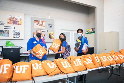 UF Student Life staff volunteers in partnership with Kids Count, a nonprofit serving elementary aged children in East Gainesville, hand out school supplies to students in the community. — © 2021 University of Florida Division of Student Affairs, All Rights Reserved