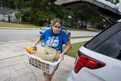 In the early stages of the the pandemic, when those most vulnerable to the effects of COVID-19 were isolated in their homes and unable to attend to some basic necessities, UF/IFAS staff and personnel stepped up to volunteer their time in a community wide food delivery effort. The UF community is much broader than the students, faculty, and staff that occupy its campus and lecture halls. It extends to the supportive community outside its boundaries. In these challenging times UF was able to demonstrate that they value the health and well-being of the Gainesville community at large. — © 2020 UF/IFAS Communications, Photo by Tyler Jones