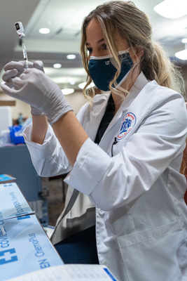 Anna Dostie, UF Pharmacy student prepares doses of the Pfizer BioNTech vaccine at UF Health Gainesville Jan. 19, 2021. As vaccines rolled out everyone in the UF Academic Health Center stepped up to do their part to aid in the overall response to the pandemic. — © University of Florida, Photo by Jesse S. Jones